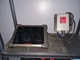 a tablet computer sitting on top of a metal table