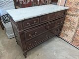 a marble top chest of drawers in a store