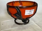 a glass bowl on a stand with a label on it