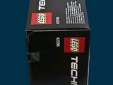 a box of lego technics sitting on a blue surface