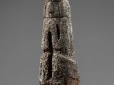 an image of a stone sculpture of a face on a stand