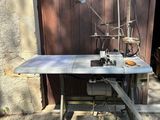 a sewing machine sitting on a table in front of a building