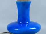 an image of a blue table lamp on a metal base