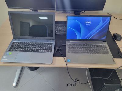 two laptops that are sitting on a desk