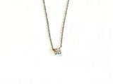 silver chain with a diamond pendant on a mannequin neck