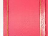 a red book with gold trim and a pink cover