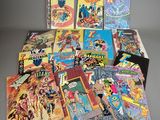 a bunch of comic books sitting on top of a table