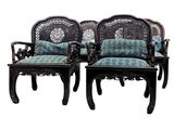 pair of carved wood chairs with blue and green upholstered cushions