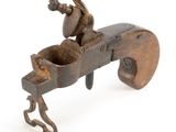 an old wooden toy gun with a man on it