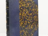 an old book with a blue cover and gold foil on it