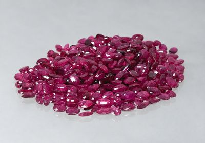 a pile of pink sapphires sitting on top of a white surface