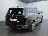 the rear end of a black suv parked in a showroom