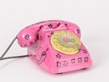 a pink telephone that has a heart design on it