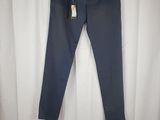 a pair of blue pants hanging on a hanger in front of a white curtain