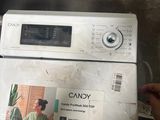a person that is putting something in the top of a washing machine