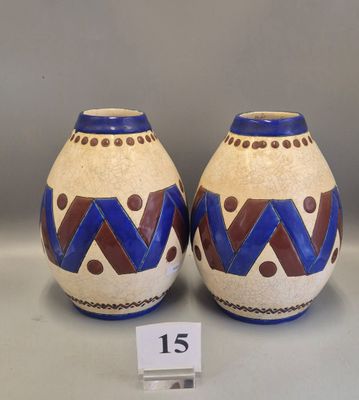 pair of ceramic vases with geometric designs on them on display