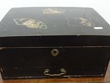 a small black box on a wooden table