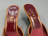 pair of women ' s red slippers with gold lettering on them