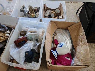 two bins filled with assorted items sitting on the floor