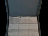 a open suitcase that has a lot of white tiles inside of it