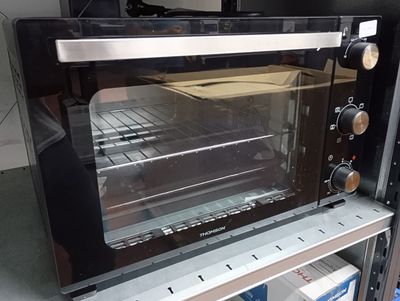 a toaster oven that is sitting on top of a shelf