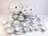 a lot of plates and cups and saucers on the table