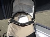 a stroller with a baby in it on the ground