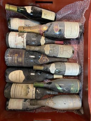many bottles of wine sitting in a red box