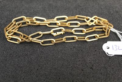 a close up of a gold chain with a tag on it