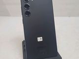 a close up of a black phone on a stand on a table