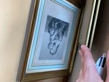 a person that is holding a cell phone near a picture