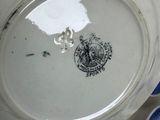 a white plate with a blue and white plate with a picture of a man on it