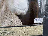 a display case with a dress and a hat on it