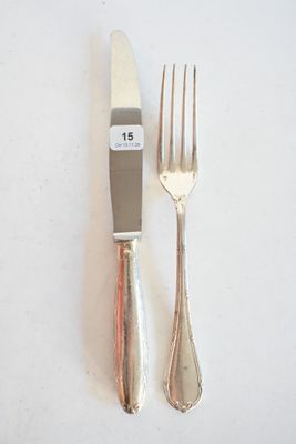 deux fourchettes et un couteau sur une table blanche