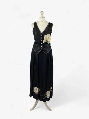 an image of a dress on a mannequin stand on a white background