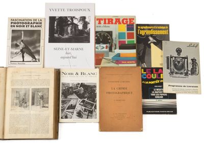 several books are stacked on top of each other on a white surface