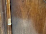 a close up of a wooden cabinet with a glass door
