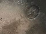 a close up picture of a dirty pot with a lid