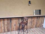 an image of a bar with a stool and a mirror