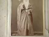 an old photo of a woman with an umbrella in her hand