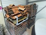 a pile of wood in a wire basket next to a toilet