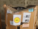 a cardboard box sitting on top of a pallet in front of a brick wall