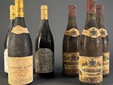 several bottles of wine are lined up on a table