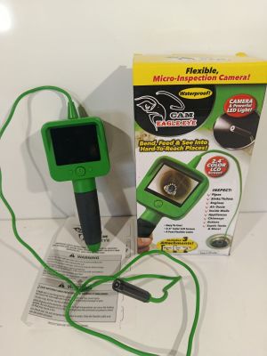 un appareil électronique vert et noir posé sur une table blanche