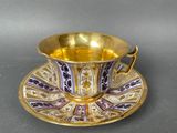 a close up of a cup and saucer on a table