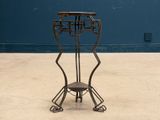 a metal chair that is sitting on a concrete floor