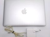 an apple laptop with a charger attached to it