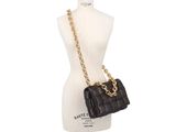a black quilted bag on a mannequin mannequin mannequin mannequin mannequin mannequin mannequin mannequin mann