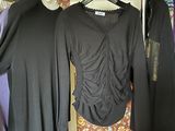 several women ' s clothing hanging on a rack in a room
