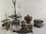 a table with a lot of silver items on it
